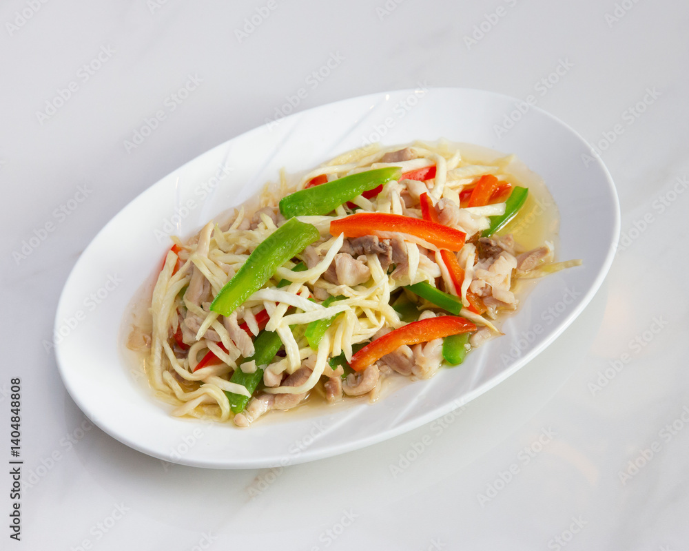 Dish of stir fried bamboo shoots with pork and bell peppers on plate Dish of stir fried bamboo shoots with pork and bell peppers on plate