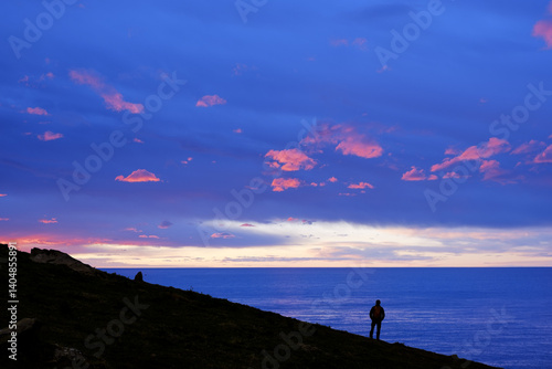 Obraz na płótnie Hiker in front of the Cantabrian Sea at sunset, Euskadi w salonie