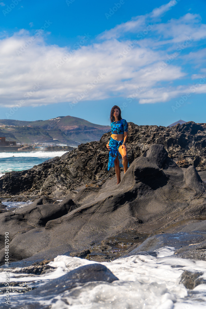 Young woman enjoying volcanic beach in arucas, gran canaria Young woman enjoying volcanic beach in arucas, gran canaria
