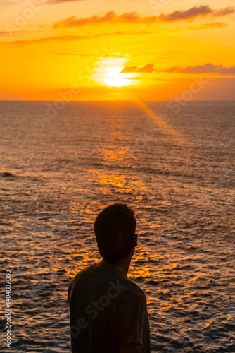 Obraz na płótnie Tourist admiring stunning golden sunset over atlantic ocean in agaete, gran canaria w salonie