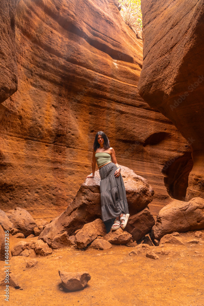 Tourist exploring the majestic barranco de las vacas in gran canaria, spain
