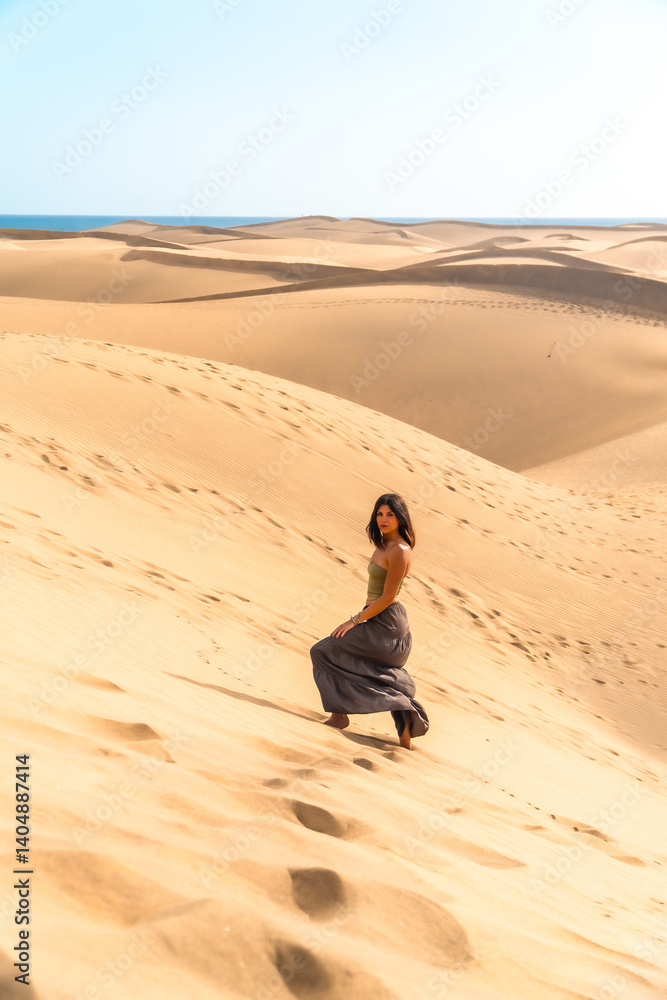 Tourist walking on maspalomas dunes in gran canaria, spain