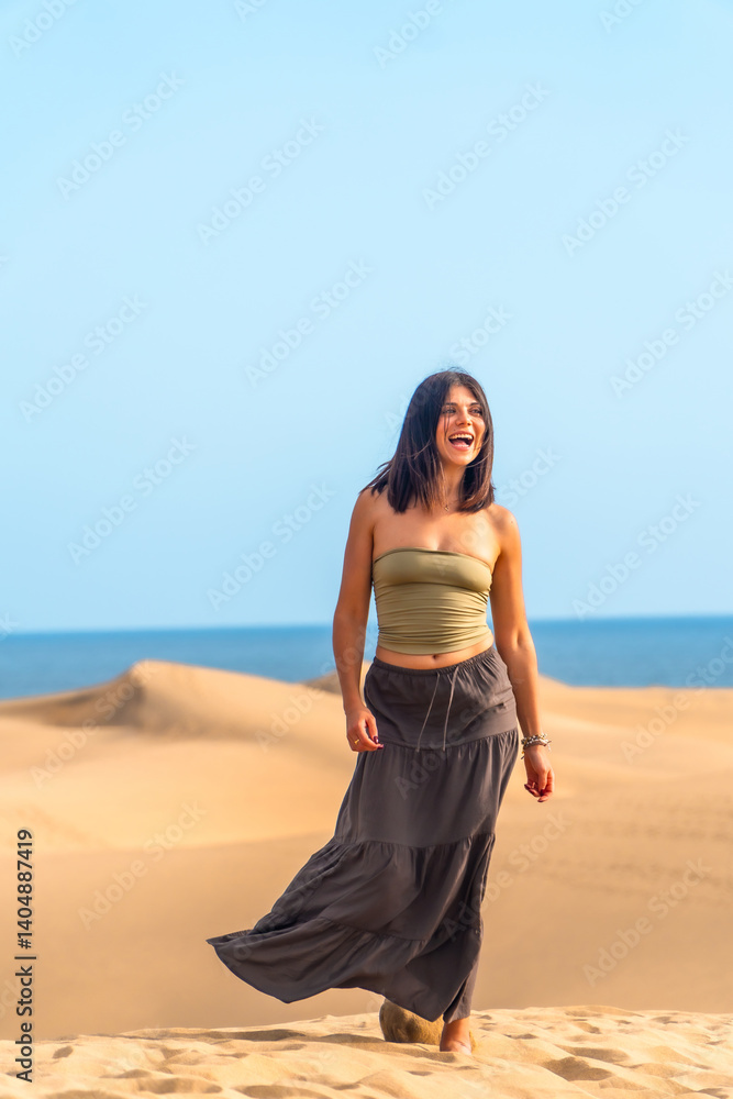 Tourist walking on maspalomas dunes in gran canaria, spain, feeling happy and carefree