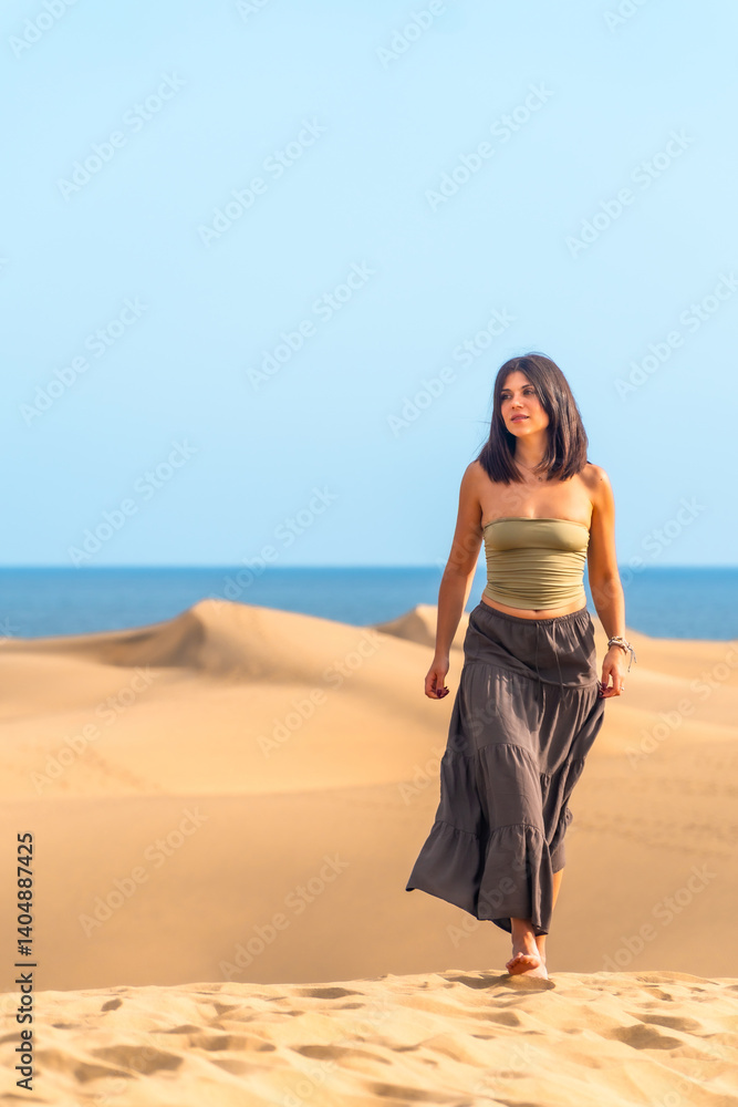 Tourist walking on maspalomas dunes in gran canaria, spain Tourist walking on maspalomas dunes in gran canaria, spain