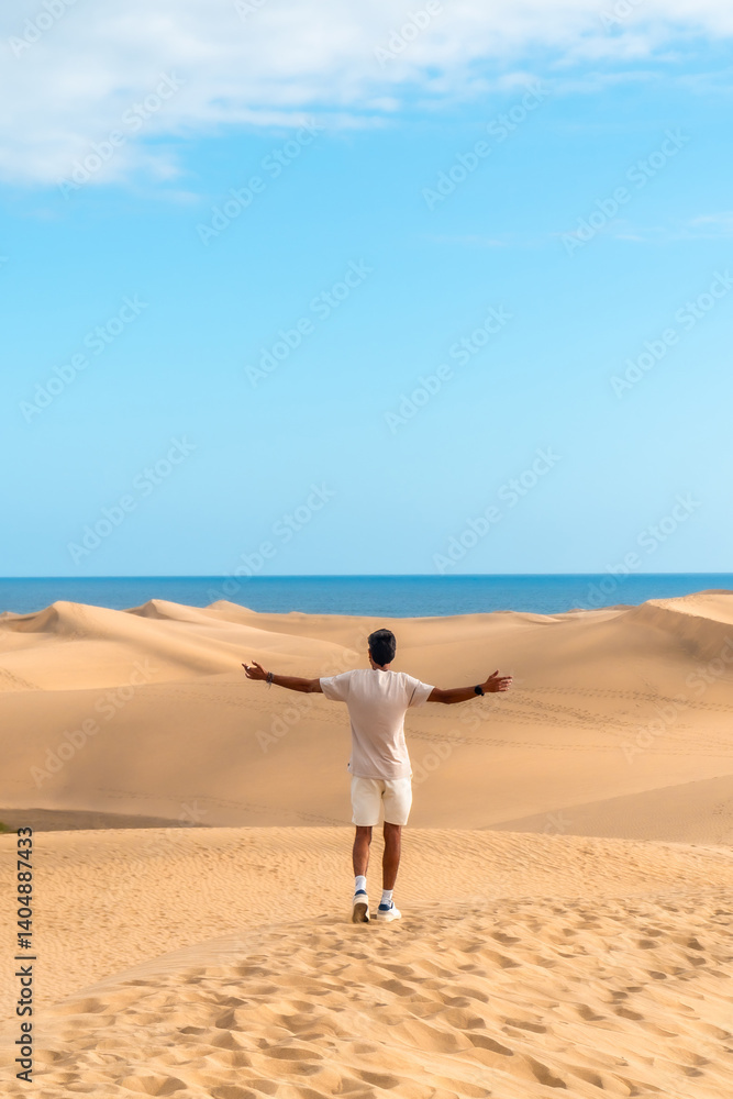 Tourist enjoying freedom in maspalomas dunes, gran canaria