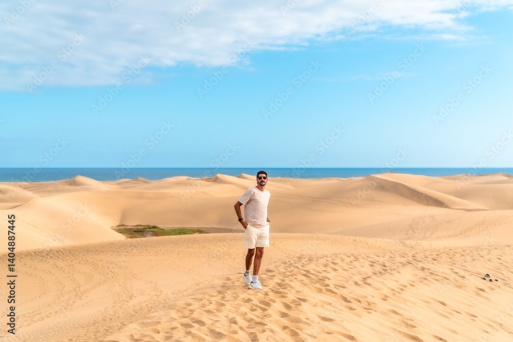 Tourist walking on maspalomas dunes in gran canaria, spain