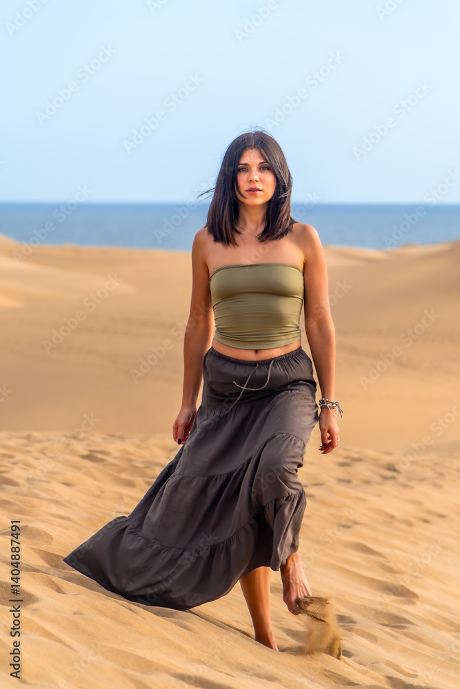 Tourist walking on maspalomas dunes beach in gran canaria, spain
