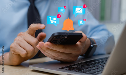 Businessman using smartphone with notification icons on virtual screen. Push notifications, email and message notifications, online shopping web, timetable work.