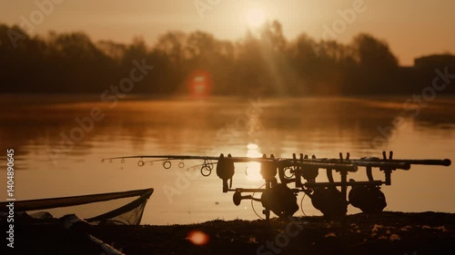 Carp fishing rods at sunrise lakeside angling scene