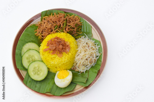 Nasi kuning or yellow rice or tumeric rice is a traditional Indonesian food, made from rice cooked with turmeric, coconut milkspices served with eggs, shredded fish, rice vermicelli, fried noodles.