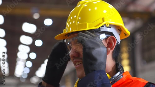 Close up asian man technician engineer wearing and adjust protective safety glasses. Safety equipment for industry factory. Safety at work concept.