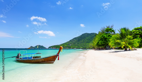 Thai traditional wooden longtail boat and beautiful sand beach at Koh Tao island in Thailand.