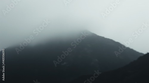 Obraz na płótnie Misty mountain peak shrouded in dense fog on overcast day w salonie