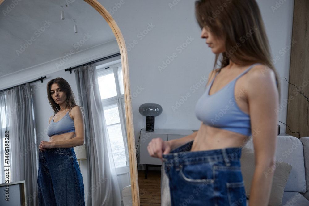 Mirror reflection of too much underweight woman with anorexia disorder