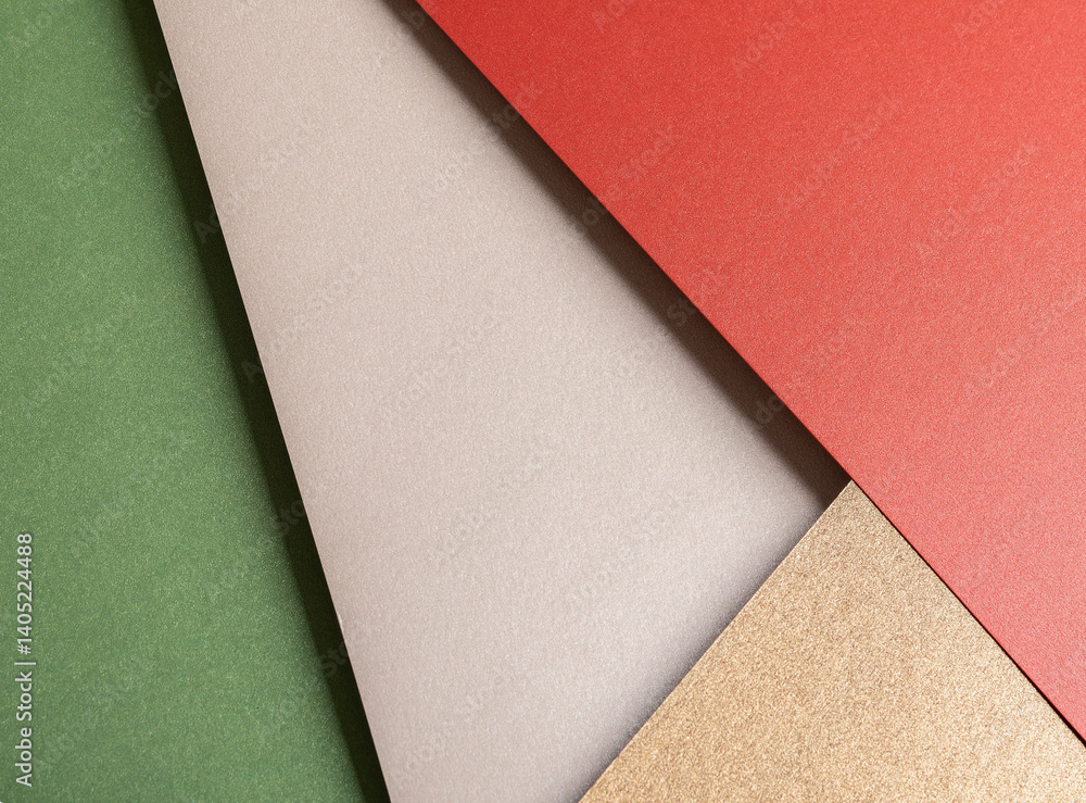 Fototapeta premium Paper background with matte texture. Layered diagonal sheets in crimson red, champagne, soft beige, metallic brown, and pastel green tones, elegant festive composition, stylish natural contrast..