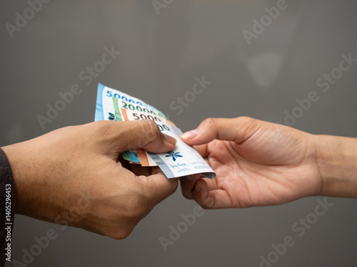 Handing over Rupiah: Transactions in Indonesia.
