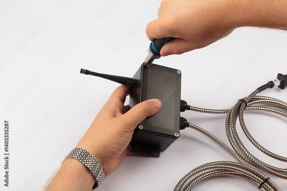 Hands of a master holding an electronic board on a white background