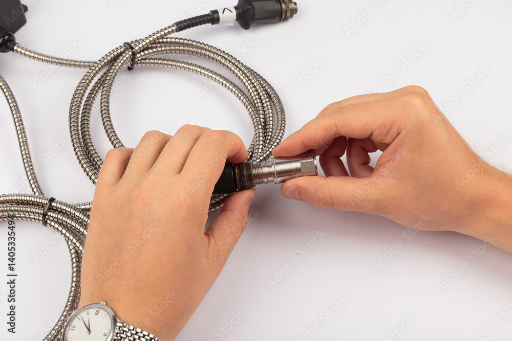Hands of a master holding an electronic board on a white background
