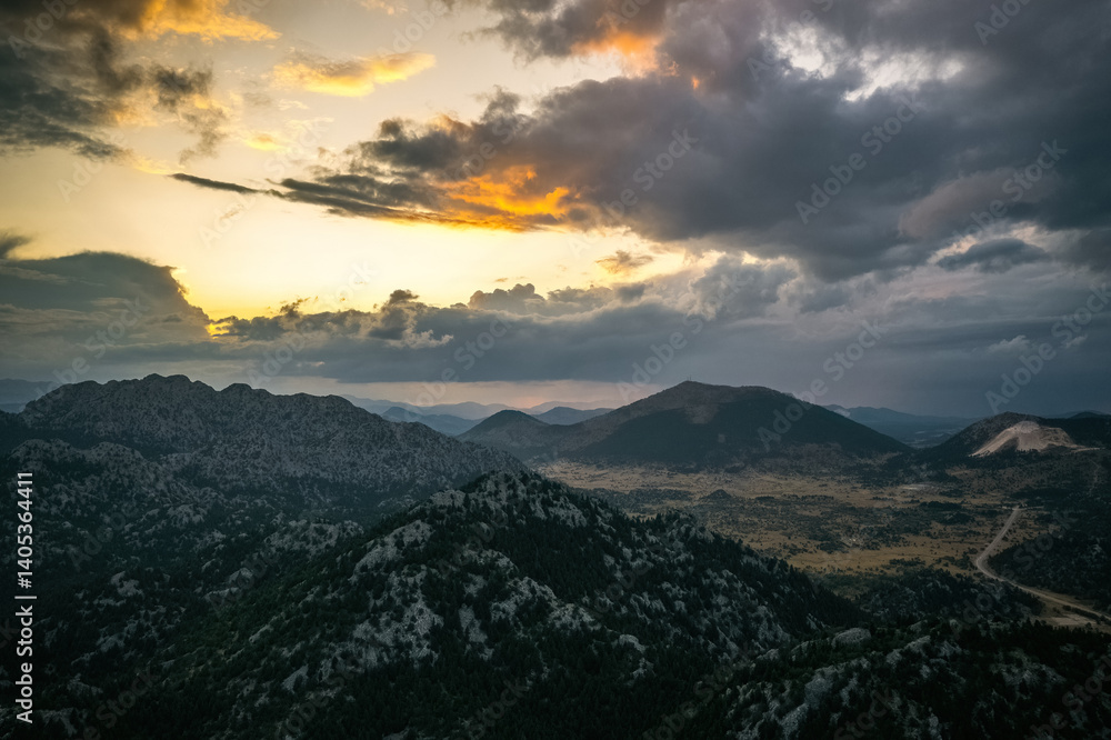 The magnificent big mountains covered with trees in Akseki district of Antalya. The sun is illuminating the sky from between the clouds.