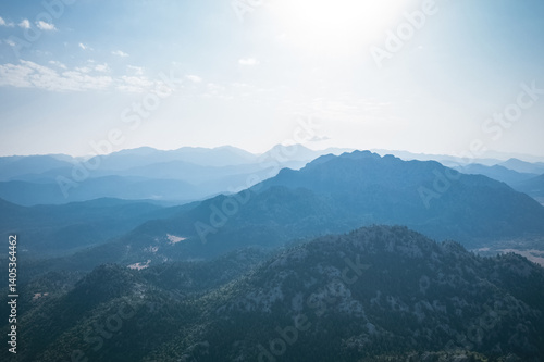 Obraz na płótnie Magnificent nature with mountains and forests. Beautiful sunny valley with blue sky in summer. Aerial view with drone. w salonie