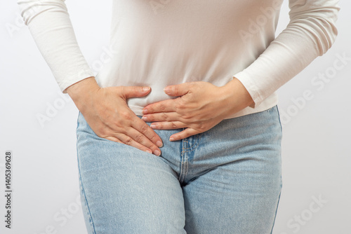 Quadro su tela Woman holding lower abdomen from side