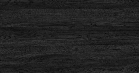 A black abstract wooden texture surface background with a grain pattern. The surface is dark and has a wood grain pattern.