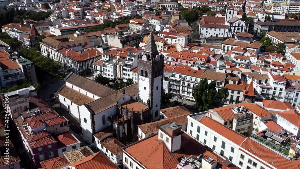 Aerial view of Cityscape of Funchal City with Funchal Cathedral, the houses are with brown roofs Aerial view of Cityscape of Funchal City with Funchal Cathedral, the houses are with brown roofs