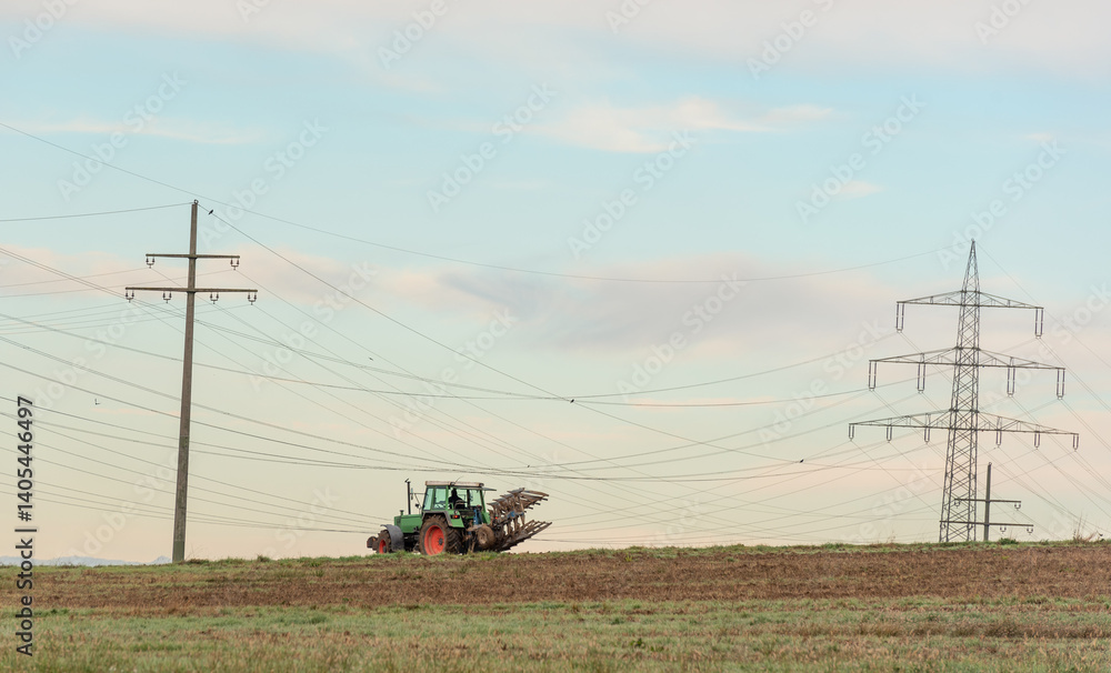 Fototapeta premium Tractor working the agricultural fields outside of Stuttgart city, Germany