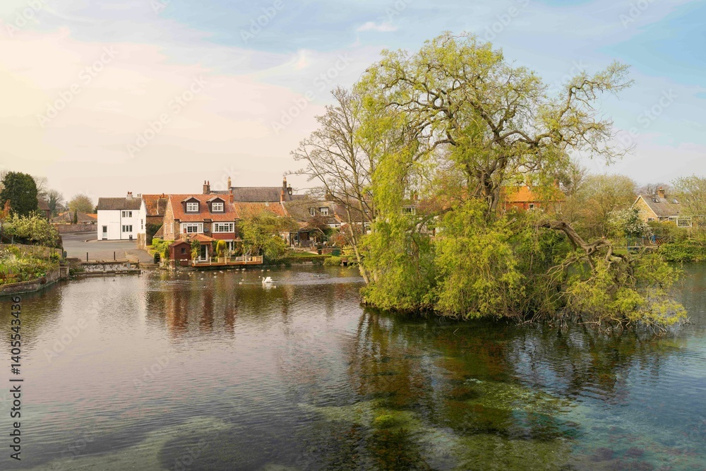 Fototapeta premium View of the mere, lake, at sunset in Nafferton, Yorkshire, UK.