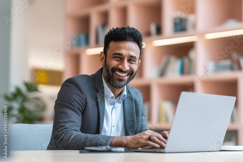 Wallpaper Mural miling indian business man working on laptop at home office. Young indian student or remote teacher using computer remote studying, virtual training, watching online education webinar at home office. Torontodigital.ca