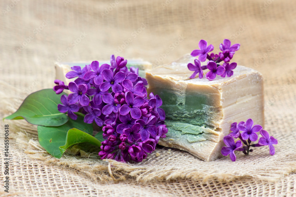 bar of natural soap and lilac flowers - aromatherapy