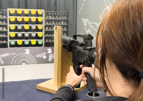 Girl is training shooting with an air rifle