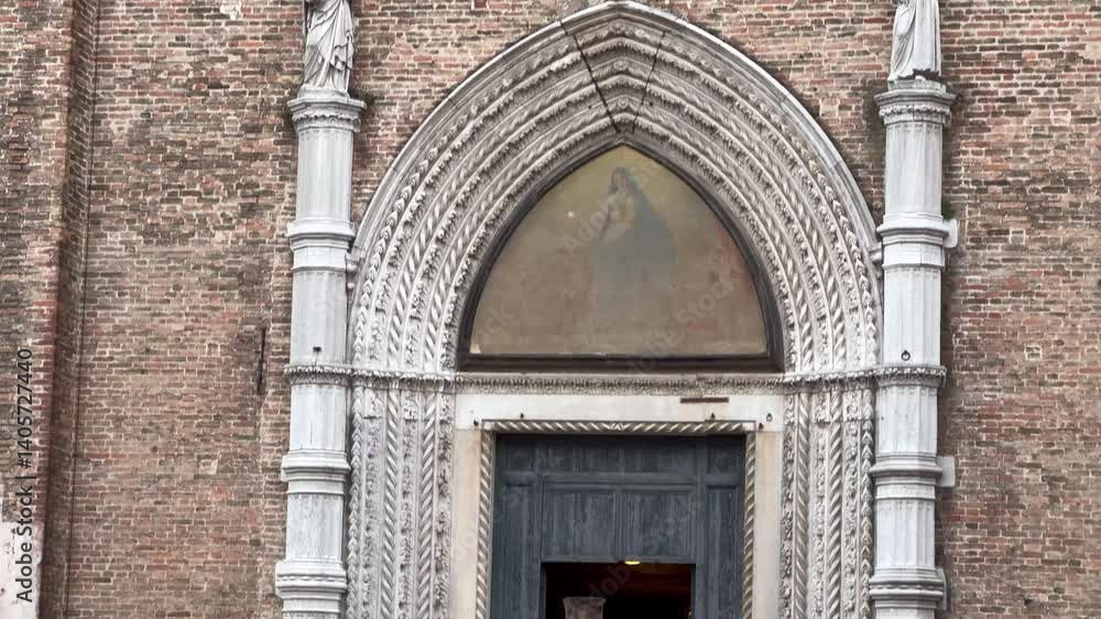 Venice, Italy - 2024 April 17: A picturesque view of Venice, Italy, showcasing a brick church facade, a small bridge over a canal, colorful buildings, and people enjoying the scenery Venice, Italy - 2024 April 17: A picturesque view of Venice, Italy, showcasing a brick church facade, a small bridge over a canal, colorful buildings, and people enjoying the scenery
