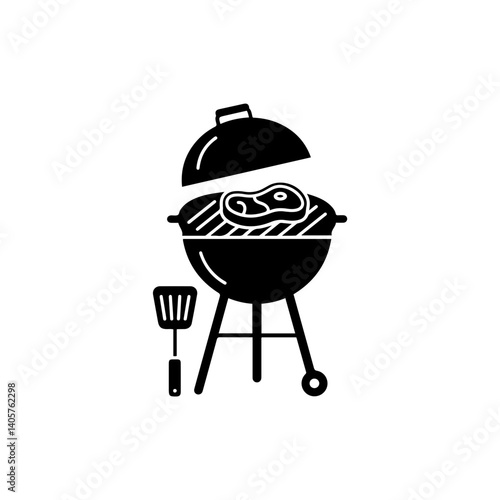 Barbecue grill with spatula and heart steak for Father's Day cookout