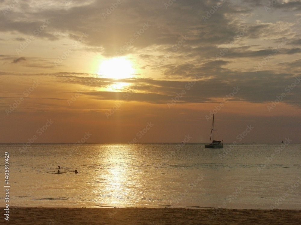 Sunset Serenity with Swimmers and Sailboat in View Sunset Serenity with Swimmers and Sailboat in View