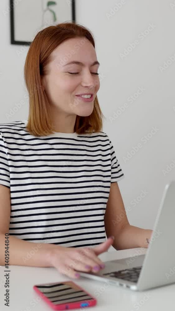 Vertical HD video of happy young business woman having video call on laptop from home. Freelancer and entrepreneur people concept Vertical HD video of happy young business woman having video call on laptop from home. Freelancer and entrepreneur people concept