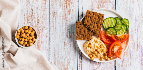 Vegetarian plate with chickpeas and vegetables on the table top view web banner