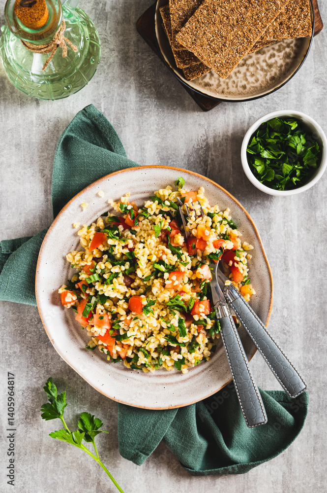 Traditional vegetarian tabbouleh salad on a plate on the table top and vertical view