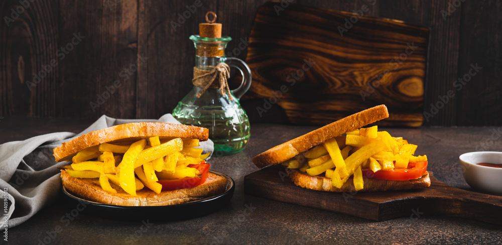 Fried toasts with french fries and tomato on a board on the table web banner