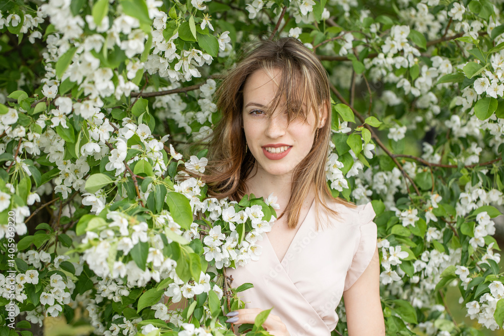 Young beautiful girl posing in a blooming garden Young beautiful girl posing in a blooming garden