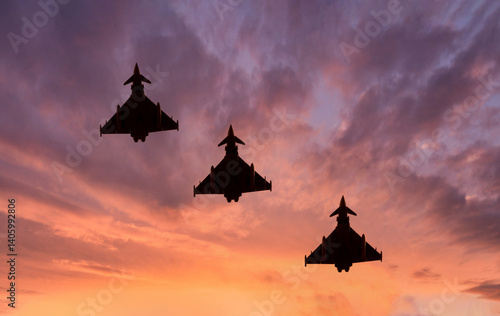Fotografija Typhoon Fighter Jet silhouettes on a combat mission at sunset