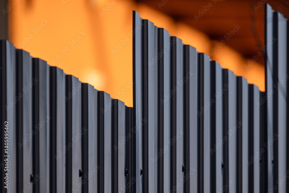 An abstract close-up view of a modern metallic fence
