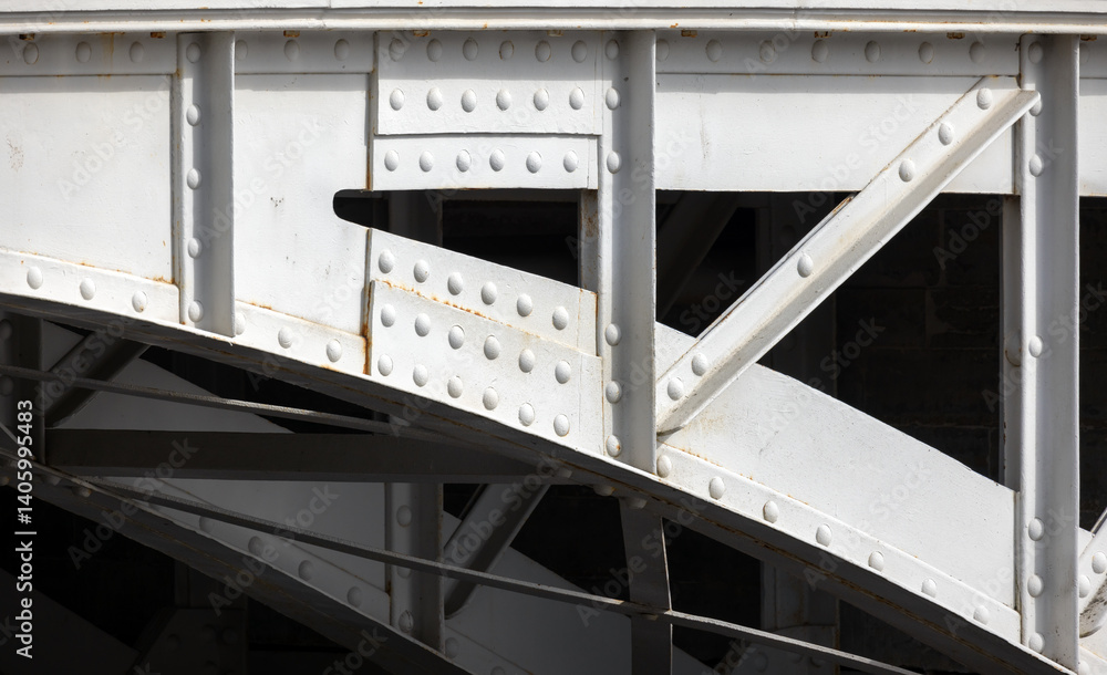 Detailed image of a metal bridge structure, focusing on the rivets