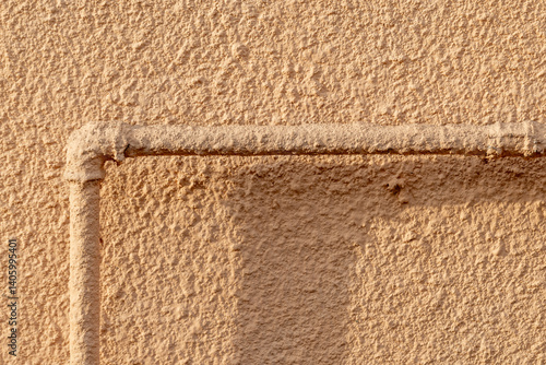 Obraz na płótnie Rourh industrial beige wall with a pipe. Abstract background texture w salonie