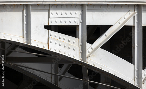 Obraz na płótnie Detailed image of a metal bridge structure, focusing on the rivets w salonie