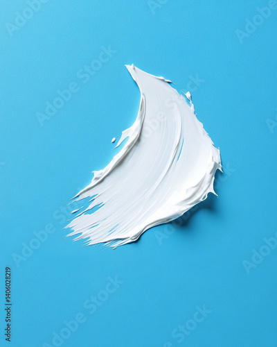Obraz na płótnie A close-up, high-resolution texture shot is present in the White Cosmetic Cream swatch, which is situated on a blue background. w salonie