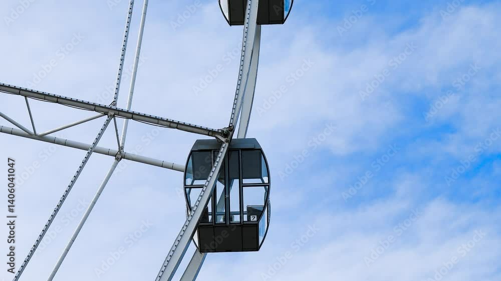 A majestic Ferris wheel stands tall against a clear blue summer sky A majestic Ferris wheel stands tall against a clear blue summer sky