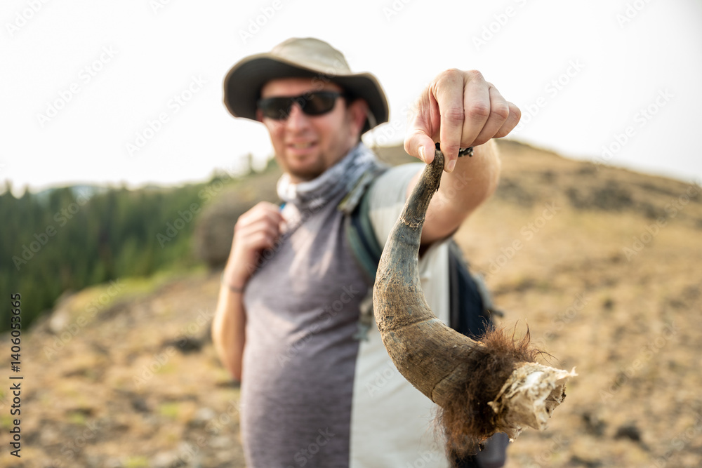 Man Holds Horn of Bison