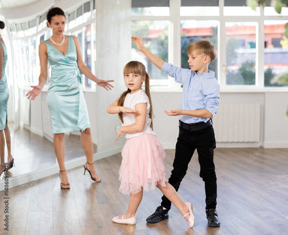 Couple of boy and girl kids twirling while taking hustle dancing lessons. Couple of boy and girl kids twirling while taking hustle dancing lessons.
