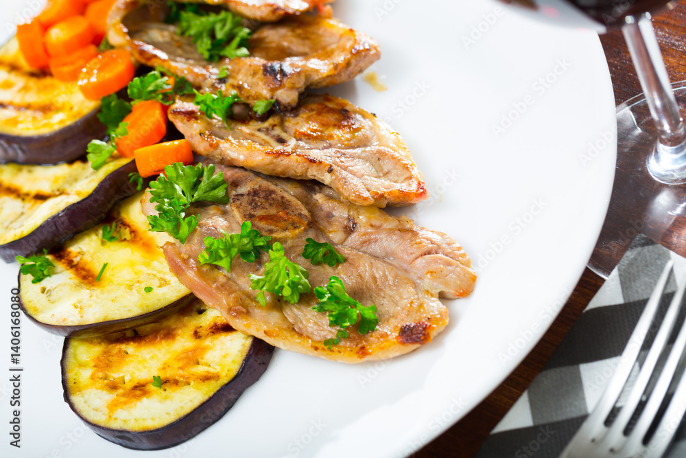 Appetizing grilled lamb chops with vegetable garnish of eggplant, carrots and greens Appetizing grilled lamb chops with vegetable garnish of eggplant, carrots and greens